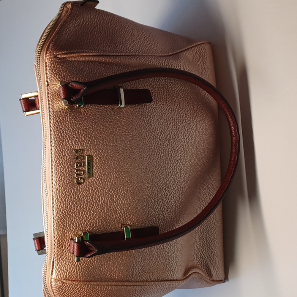 Guess rose gold bag with brown straps zip closure side zipper also zip inside